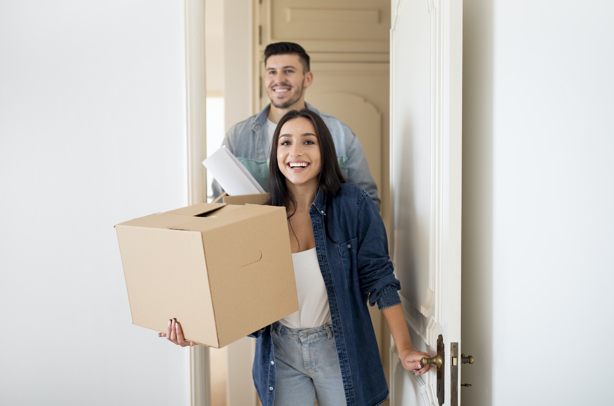 Young Happy Tenants Couple Entering Their New Home After Moving